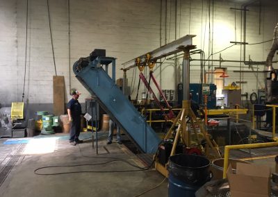 Removing a heat treating conveyor system for belt replacement