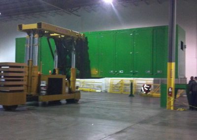 Setting a 55,000 lbs Blue Box Recycler onto frame with our 50 Ton Tri-lifter